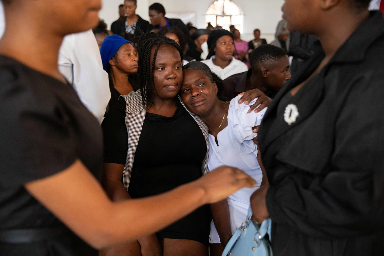 Mourners file into a church in Haiti where gangs killed dozens of people in latest rampage