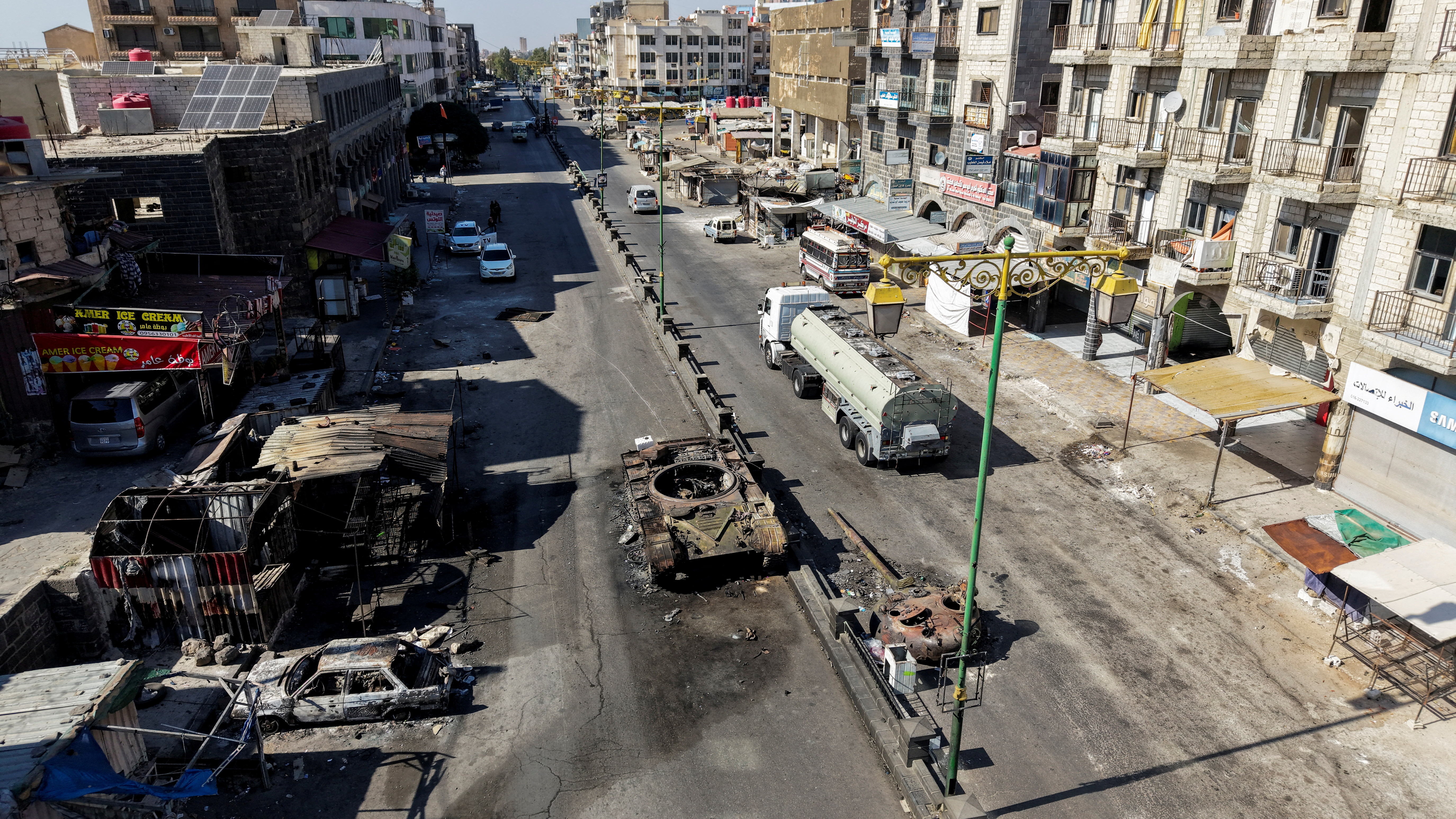 A drone view shows the remains of a destroyed tank, following deadly clashes between Druze fighters, Sunni Bedouin tribes and government forces, in Syria's predominantly Druze city of Sweida, Syria July 25, 2025. REUTERS/Khalil Ashawi      TPX IMAGES OF THE DAY