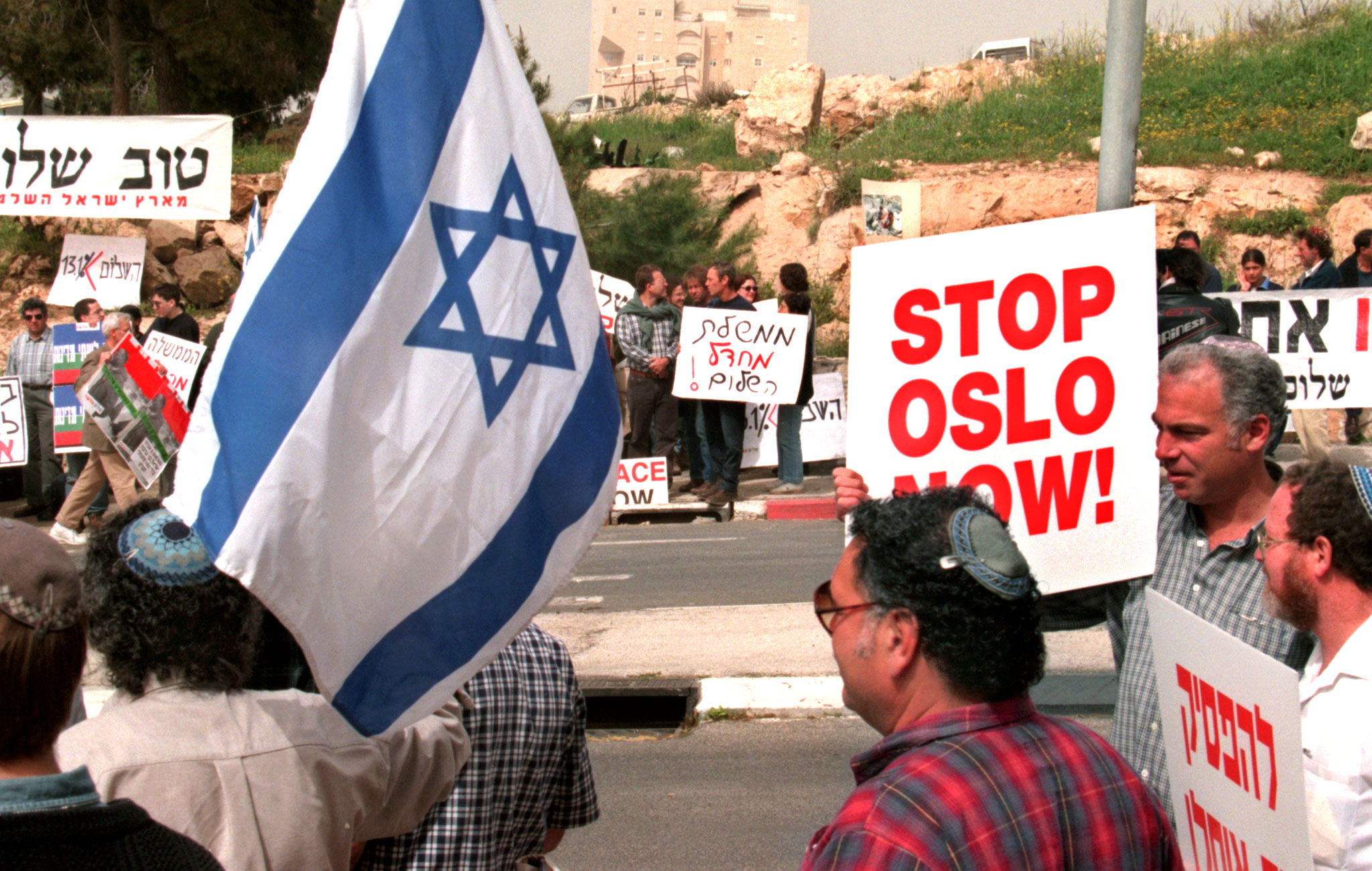 Right-wing Israeli settlers (foreground) and left-wing "Peace Now" activists (background) face each other in demonstrations outside Prime Minister Benjamin Netanyahu's office at the start of his meeting with United States peace envoy Dennis Ross March 27.