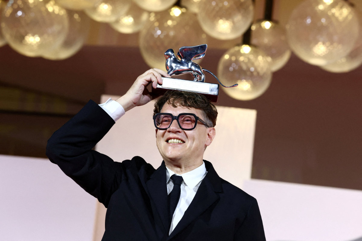 Director Ilya Khrzhanovsky poses with the Silver Lion Best Director Award for “Dau” during the closing ceremony of the 83rd Venice International Film Festival on September 12, 2026. (REUTERS/Yves Herman)