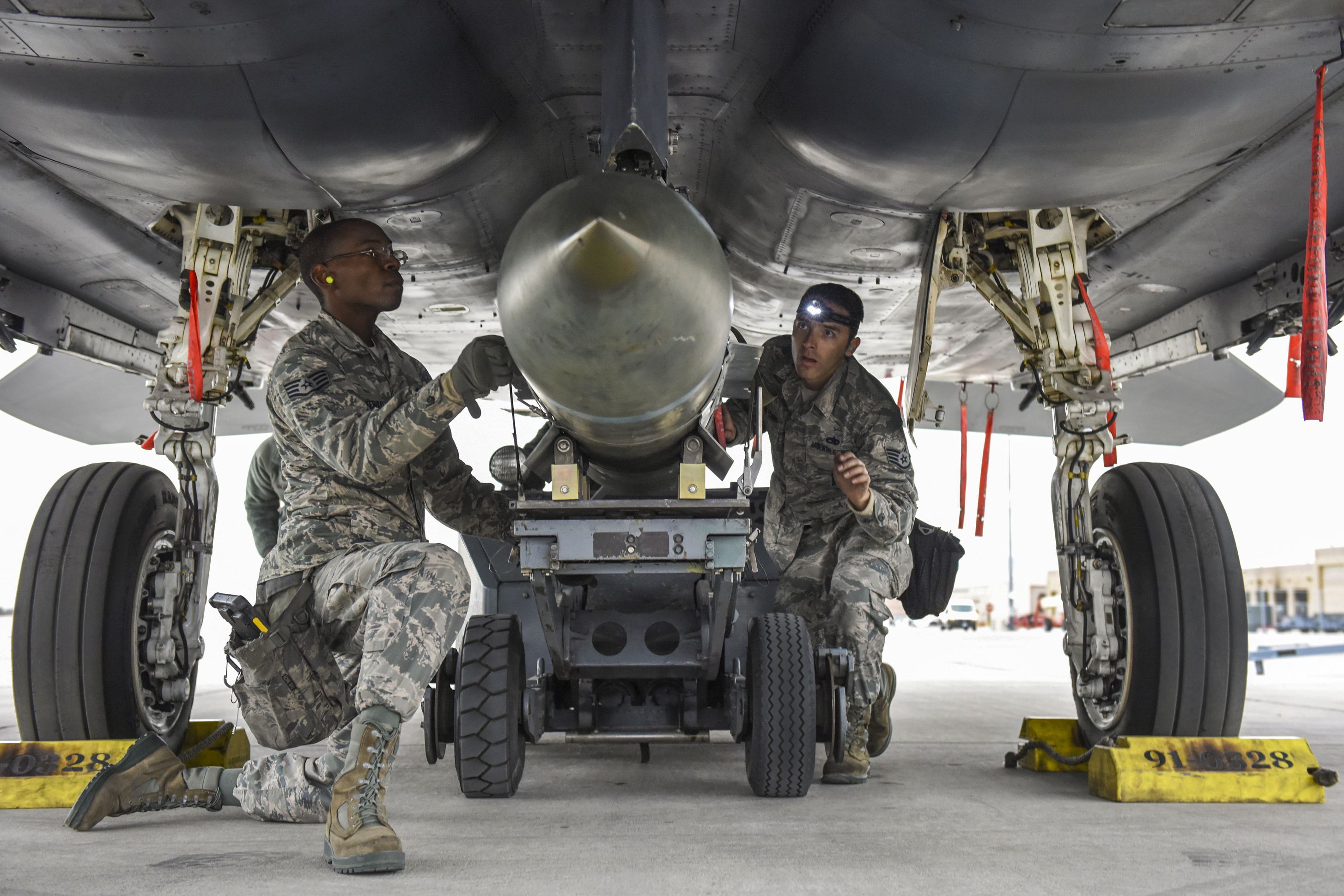Airmen assigned to the 57th Aircraft Maintenance Squadron load a BLU-117 bomb on an F-15 Eagle aircraft during the load crew competition of the year at Nellis Air Force Base, Nev. US Department of War/Airman 1st Class Andrew Sarver/File