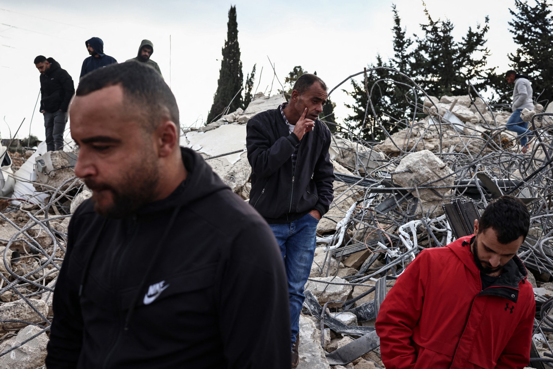 Men stand on the rubble of a Palestinian house demolished by the Israeli army in the village of Qalandia, south of Ramallah in the Israeli-occupied West Bank. (File/AFP)