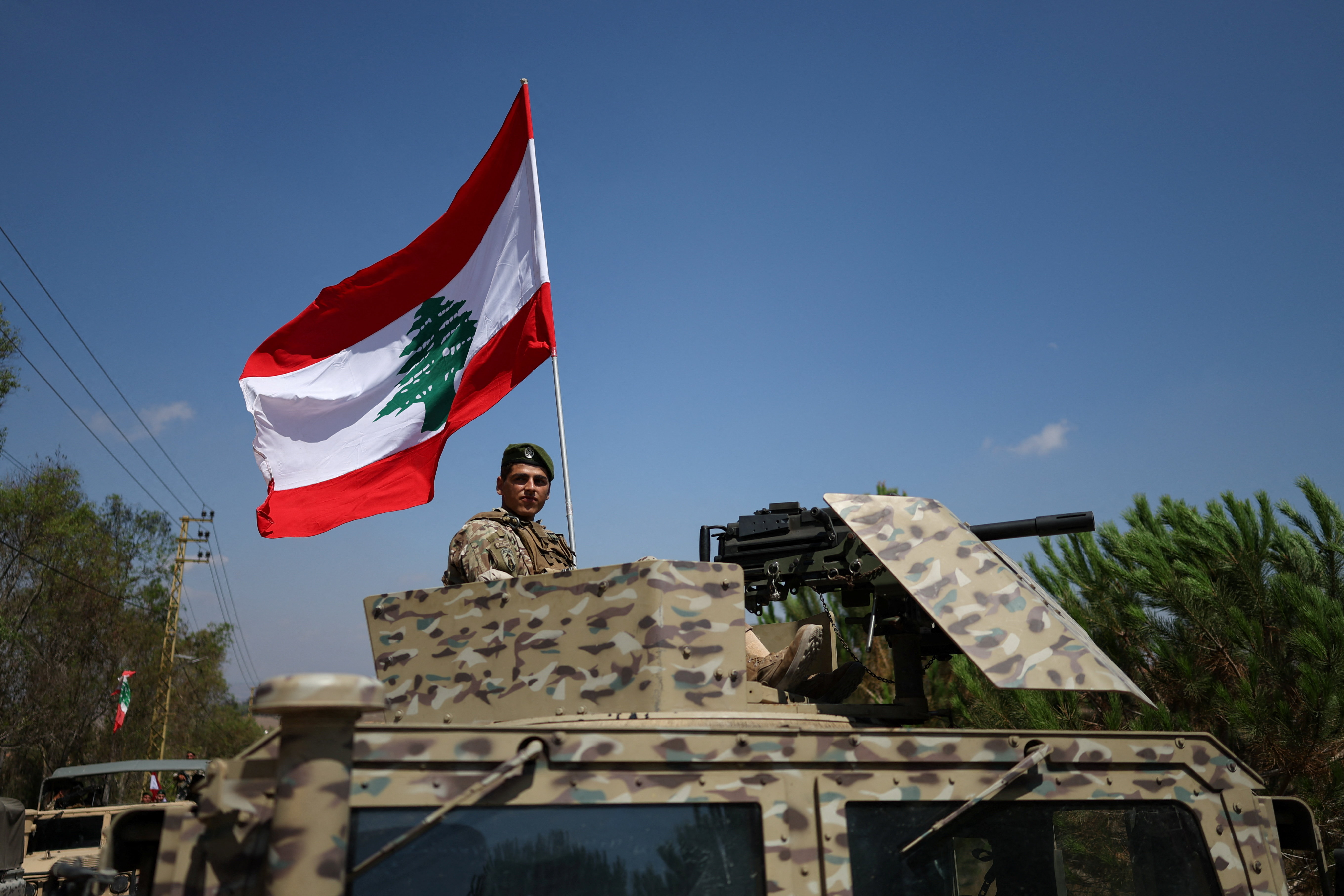 A soldier sits on an armored vehicle in Zawtar al-Gharbiyeh village, southern Lebanon, as Lebanese soldiers deploy in the area following the withdrawal of Israeli forces under a U.S.-brokered plan, July 21, 2026. REUTERS/Zohra Bensemra