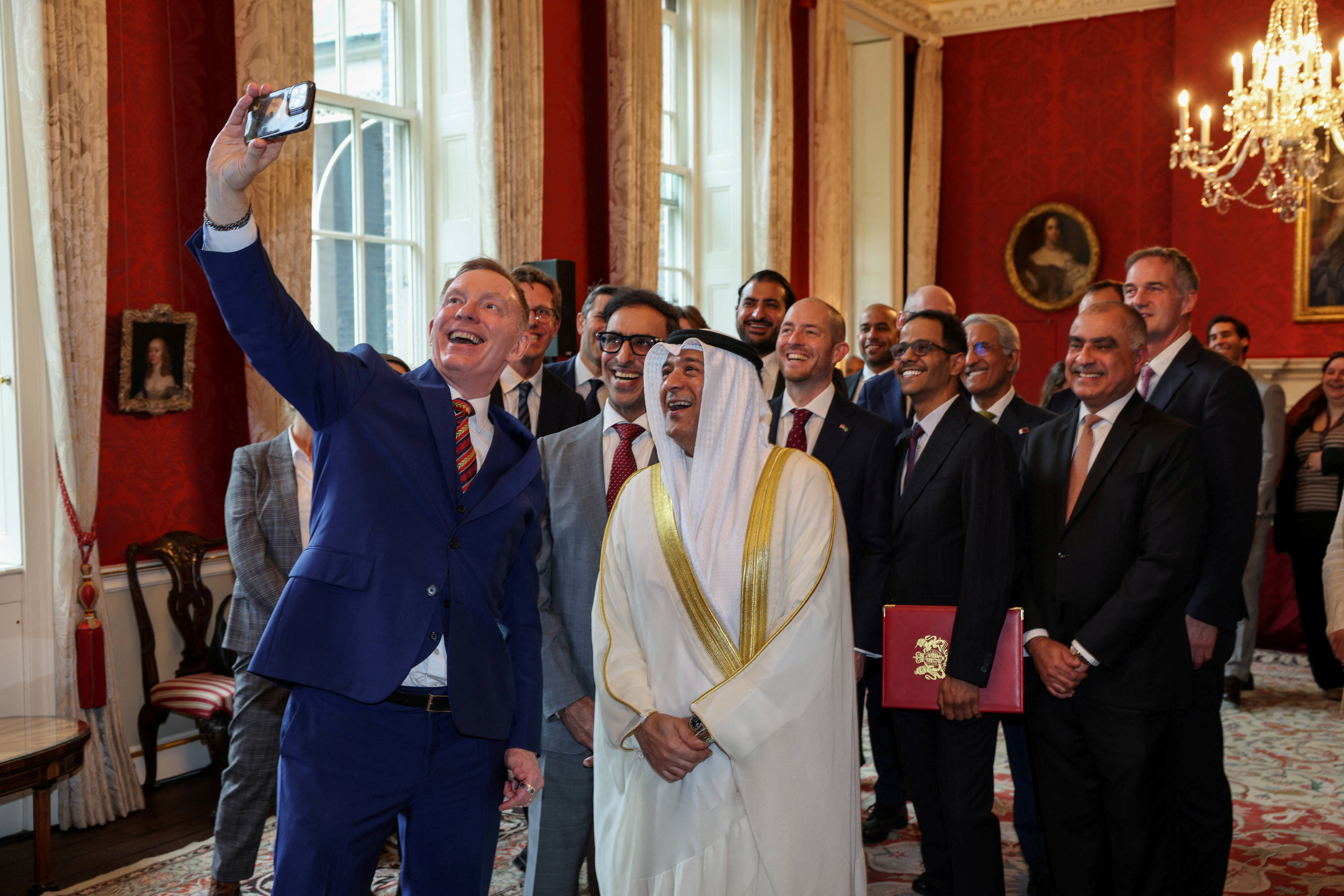 Britain Minister of State for Trade Chris Bryant takes a group photo with Jasem Mohamed Albudaiwi, secretary general of the Gulf Cooperation Council, and delegation members during a signing ceremony at Downing Street in London, Britain, May 20, 2026. (Pool via REUTERS)