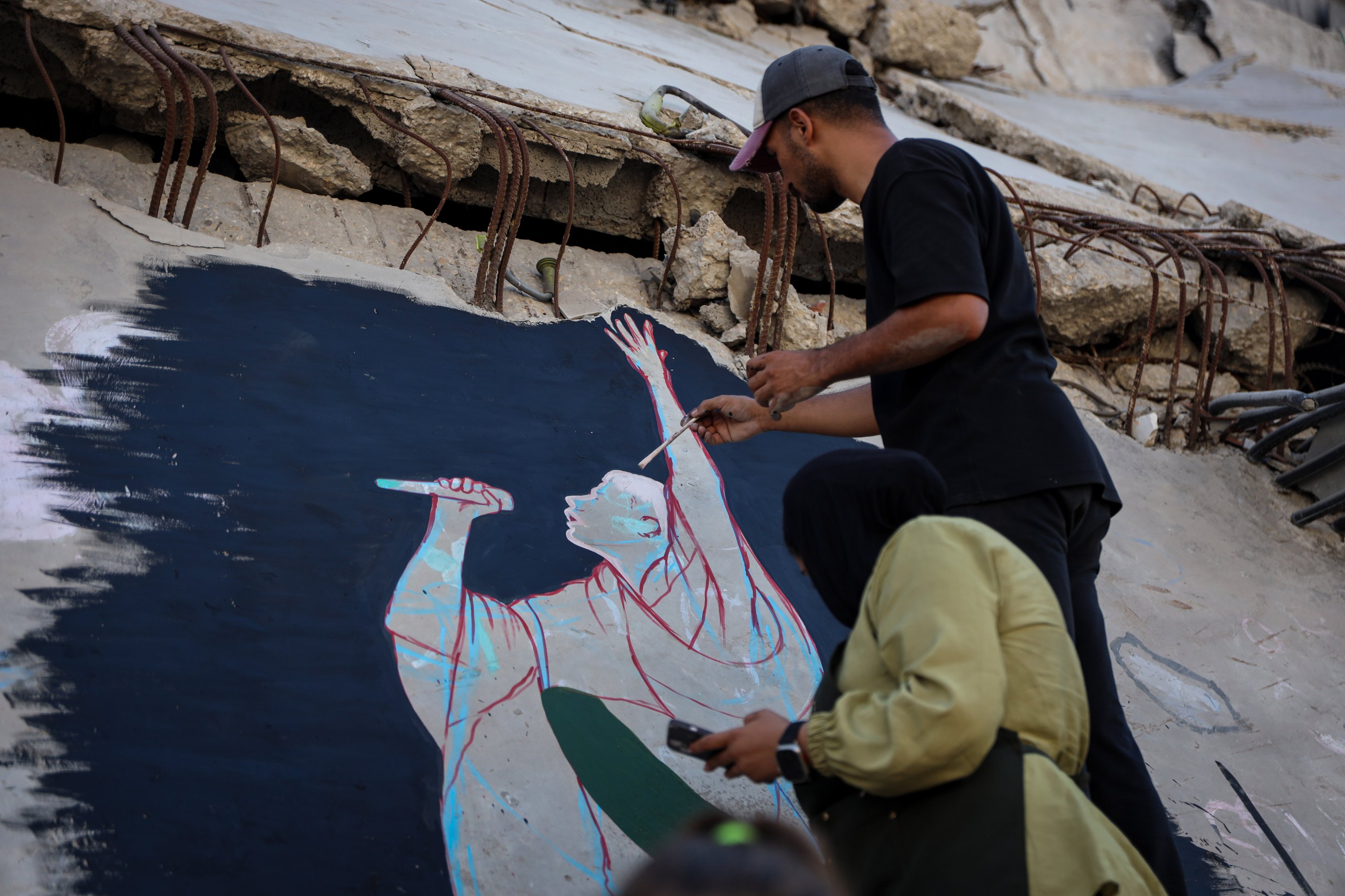 Anne Redwan, 26, ‌designed and painted the ‌mural with fellow artist Qusai Al-Helo. (Supplied)