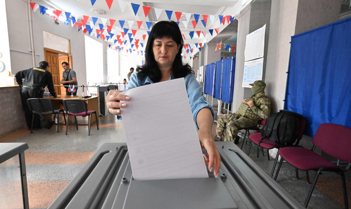 A woman casts her ballot for Russia's parliamentary election at a polling station in Donetsk, Russian-controlled Ukraine, on September 20, 2026, amid the ongoing Russian-Ukrainian conflict. (AFP)