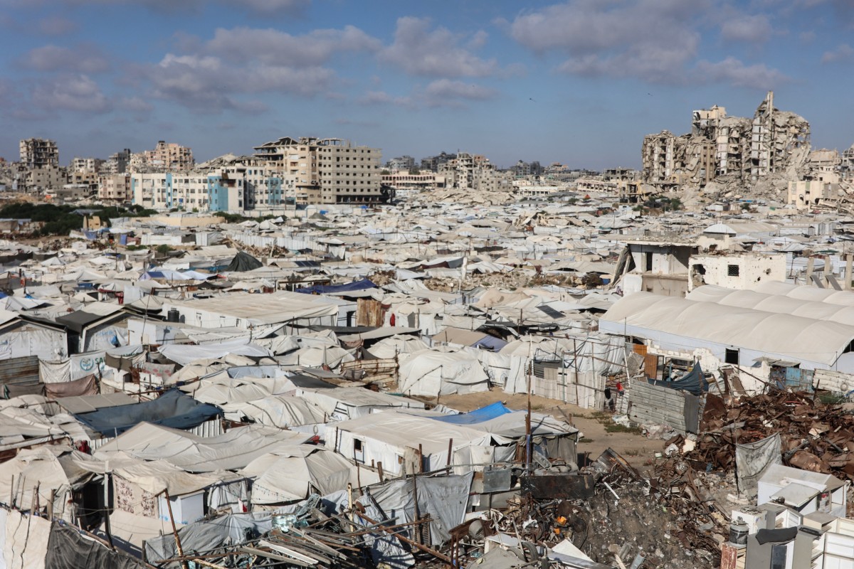 Tents and shelters are pictured next to rubble of collapsed buildings at a camp for people displaced by war in the Sheikh Radwan neighbourhood of Gaza City. (File/AFP)
