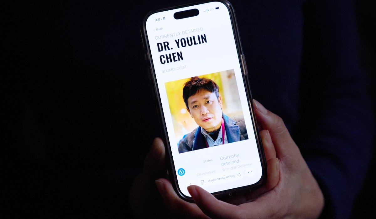 Yufang Rong, wife of U.S. citizen Youlin Chen, who she says has been wrongfully detained in China, holds a photograph of him as seen on a website about detainees on her phone, Tuesday, Sept. 22, 2026, in Washington. (AP)