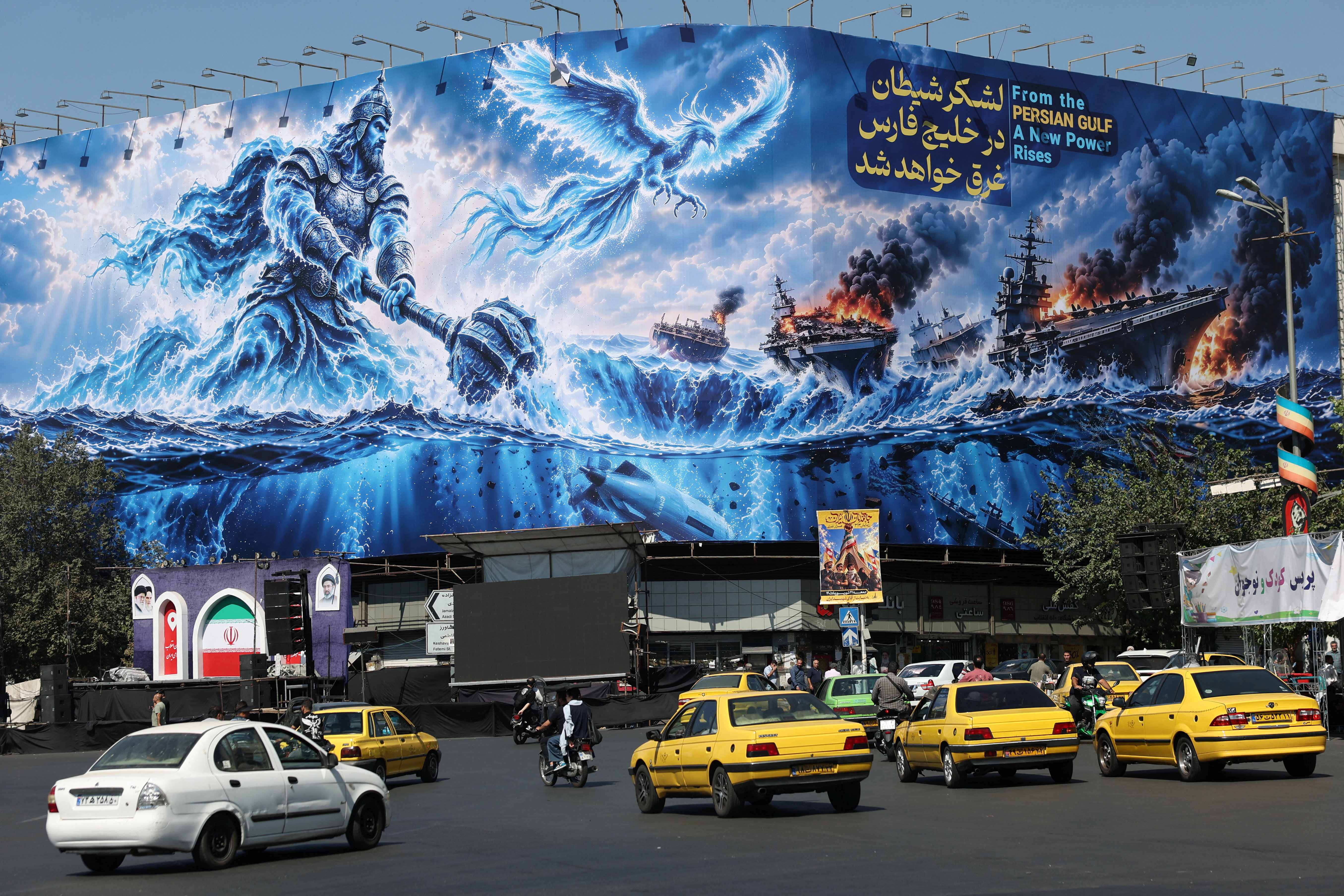 People drive past a billboard about the Strait of Hormuz, on a building in Tehran, Iran, September 16, 2026. Reuters file