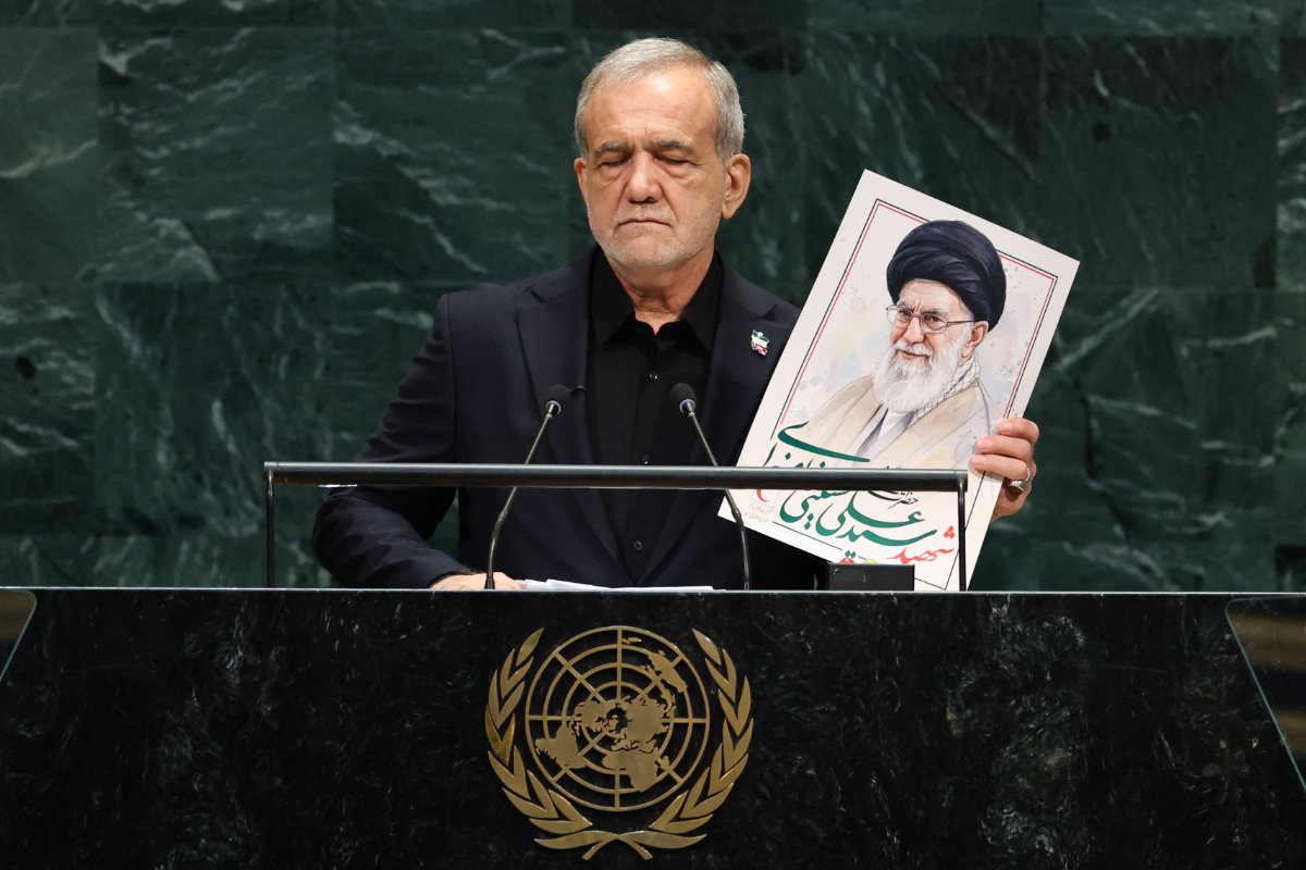 Iran’s President Masoud Pezeshkian speaks as he holds a picture of Ali Khamenei, former Supreme Leader of Iran, during the 81st UN General Assembly in New York on September 23, 2026. (AFP)