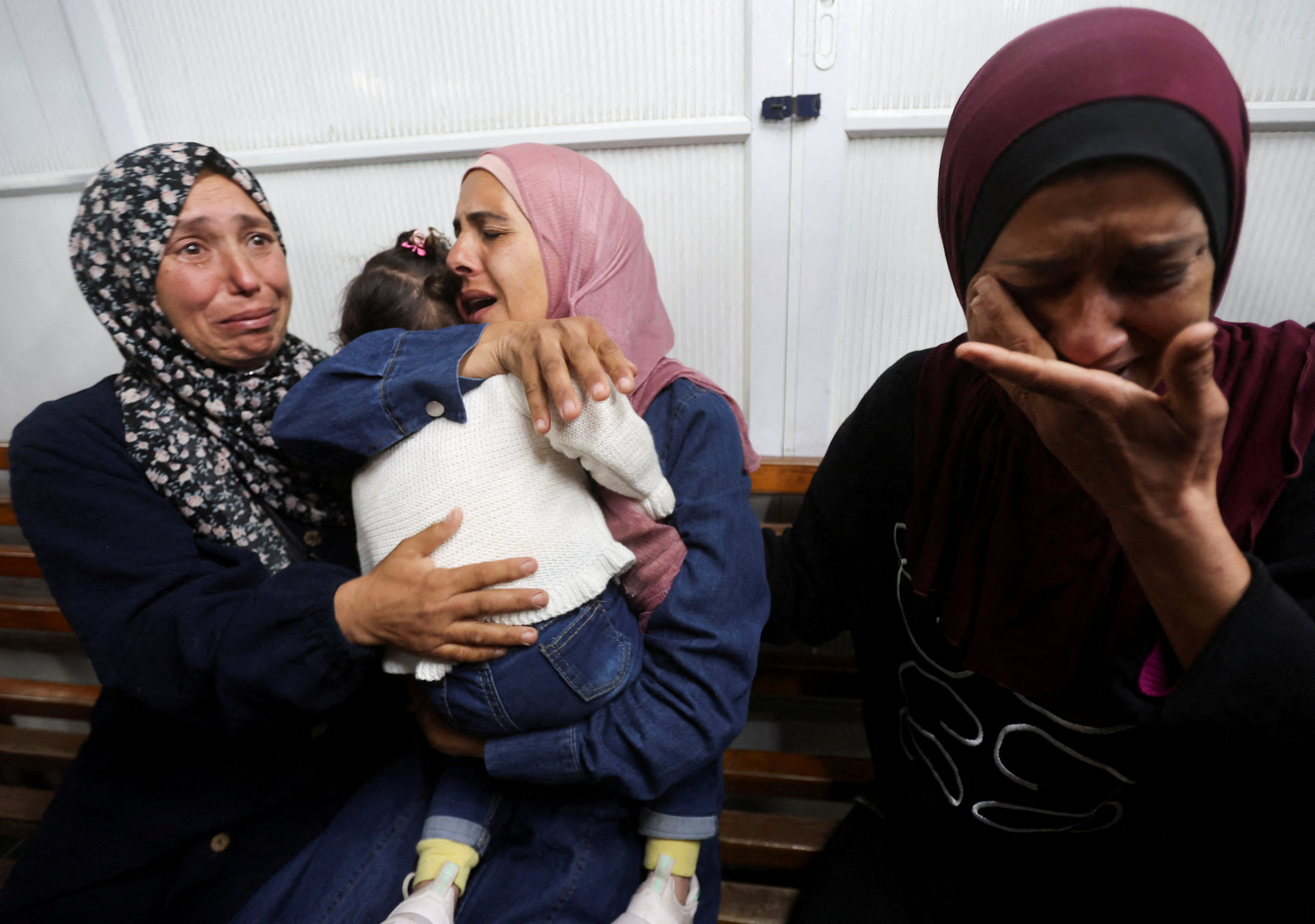 Family members reunite with a child who was evacuated from Gaza as a premature baby during the two-year Israeli offensive, and has returned after receiving medical treatment in Egypt, at Nasser Hospital in Khan Younis in the southern Gaza Strip, March 30, 2026. (AFP)