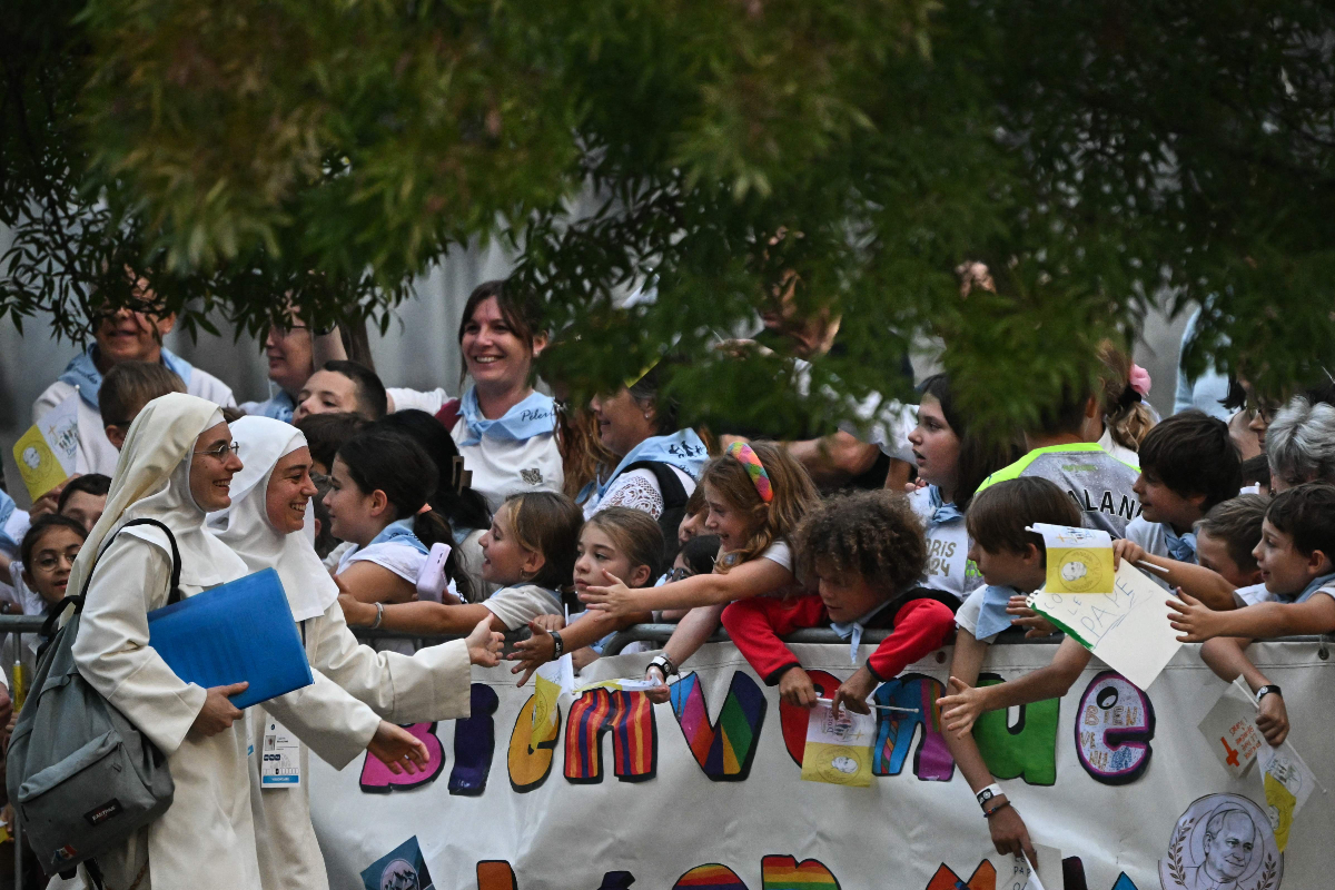 Nuns greet children as they wait for the arrival of Pope Leo XIV to lead a prayer with worshippers in the Sanctuary of Our Lady of Lourdes, southwestern France, on September 26, 2026 on the second day of his visit to France. (AFP)