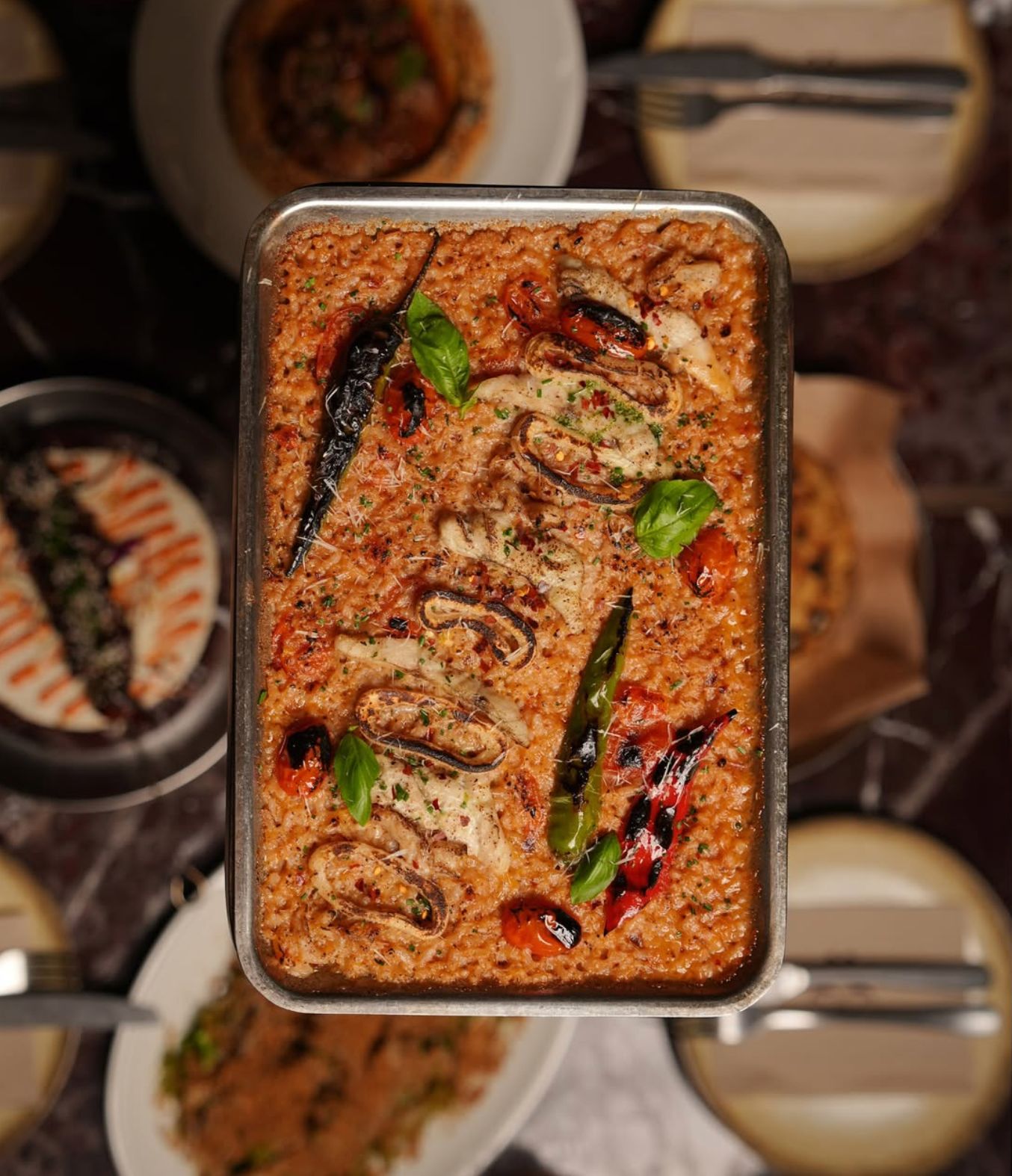 The seafood risotto combines seabass, calamari and shrimp with wood-fired tomato rice. (Supplied)