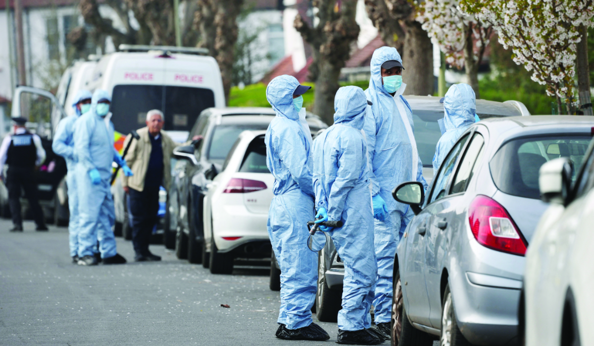Forensic officers inspect the area at a street near the scene where four ambulances belonging to Hatzola, a Jewish community organisation, were set on fire in an incident that the police say is being treated as an antisemitic hate crime, in northwest London, Britain, March 23, 2026. (REUTERS)