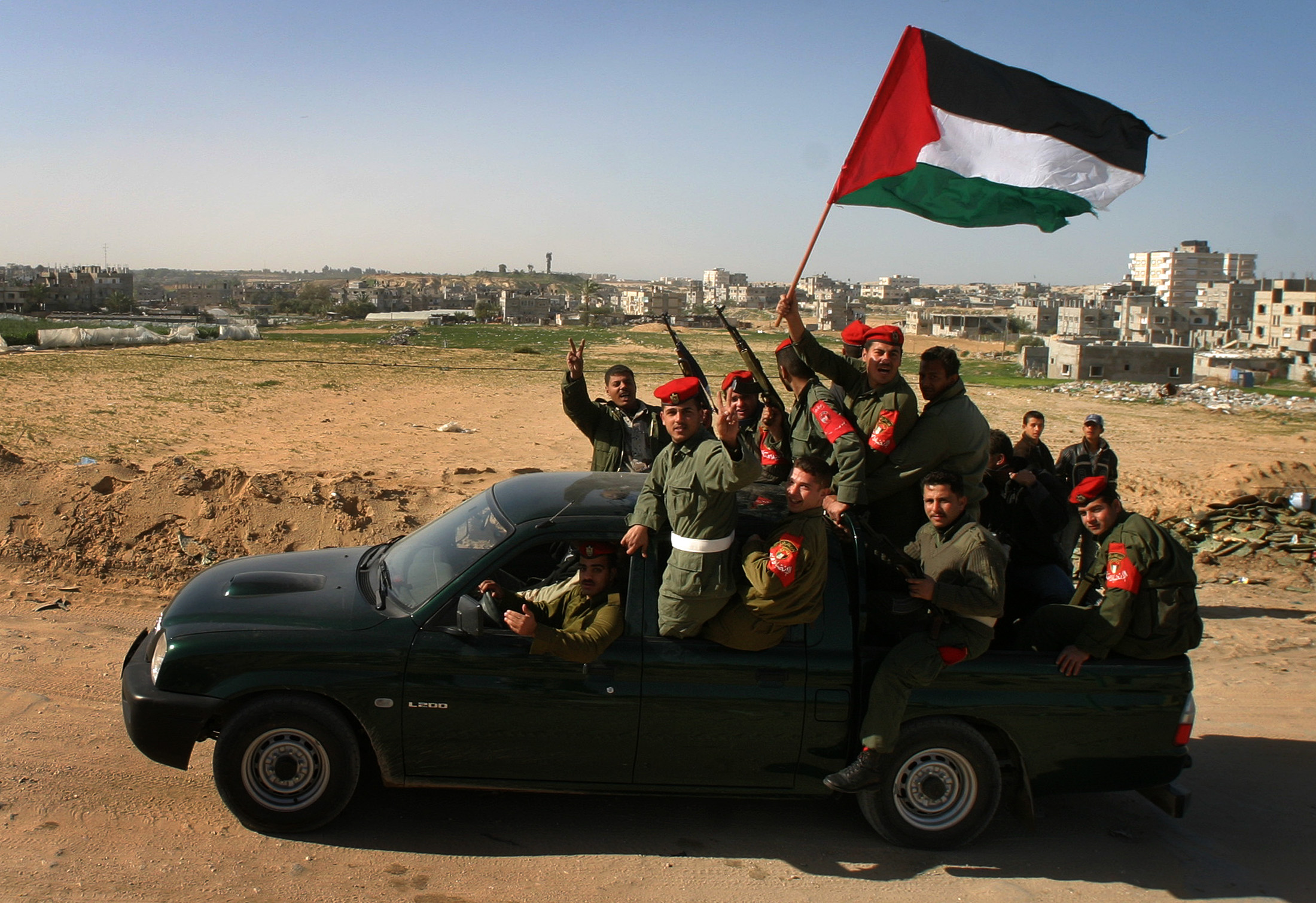 Palestinian security forces celebrate as they are deployed near the border between Egypt and the Rafah refugee camp in southern Gaza Strip. As head of the PSF in Gaza, Dahlan became one of the PA’s most powerful security chiefs. (Reuters file)