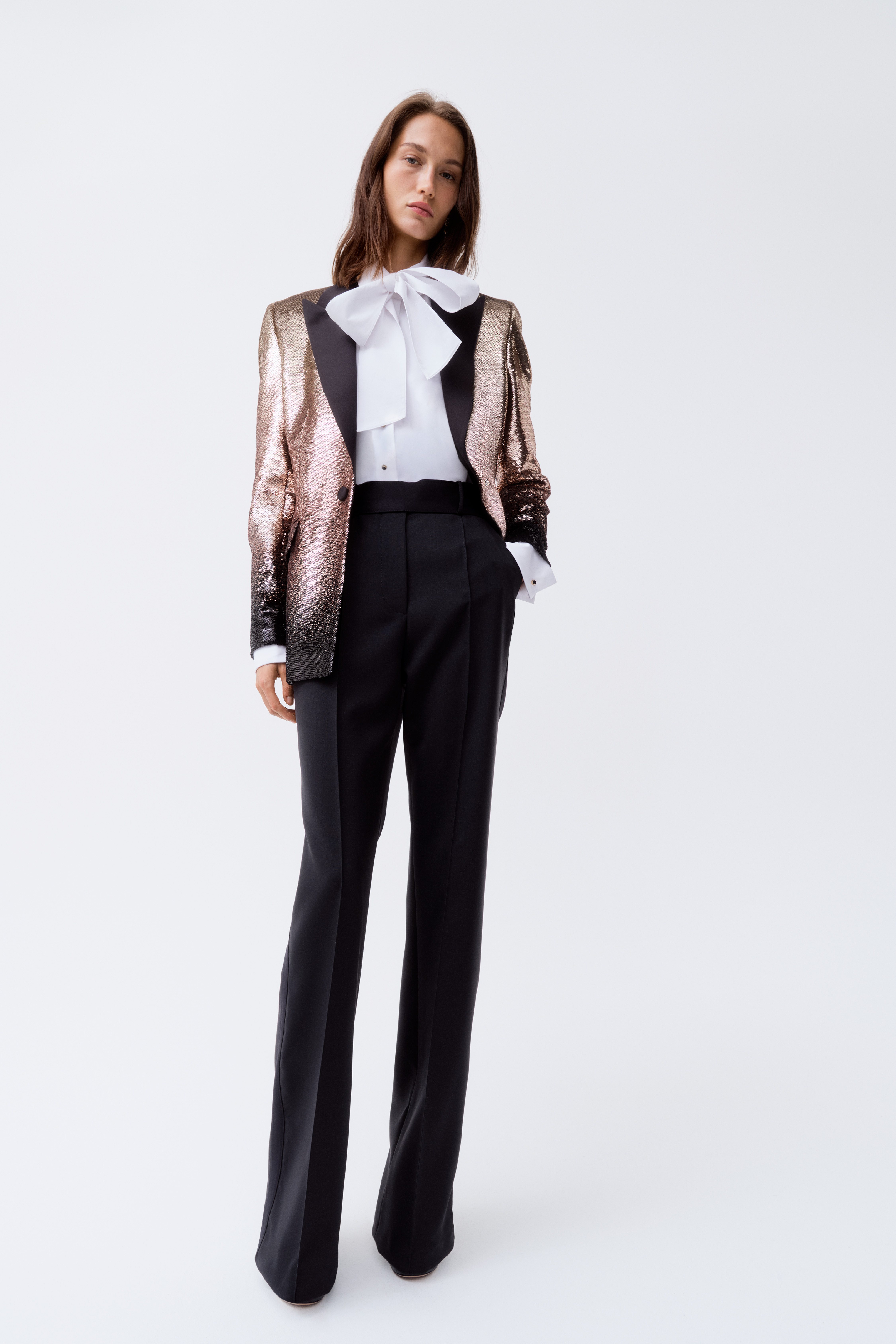 The sequined blazer, paired with tailored black trousers and a dramatic bow blouse is Elie Saab's collection with Swedish high-street retailer H&M. (Supplied)