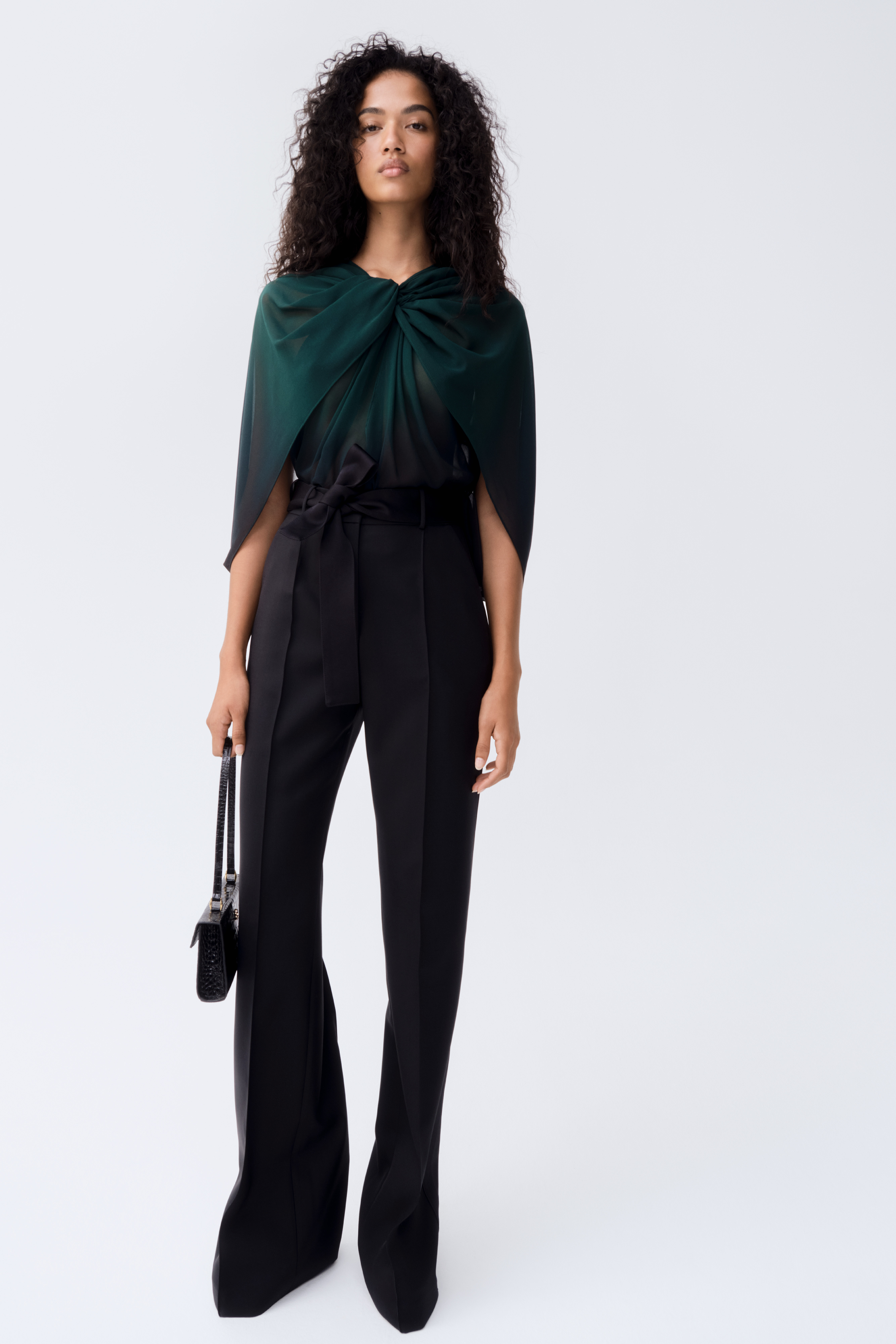 The draped green top and tailored black trousers is from Elie Saab's collection with Swedish high-street retailer H&M. (Supplied)