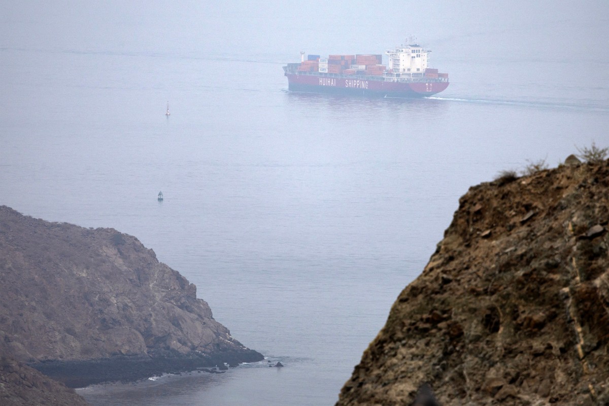 The Chinese-flagged container ship Hui Fa transits the Gulf of Oman off Khor Fakkan, UAE, amid uncertainty over regional trade and growth. (AFP)