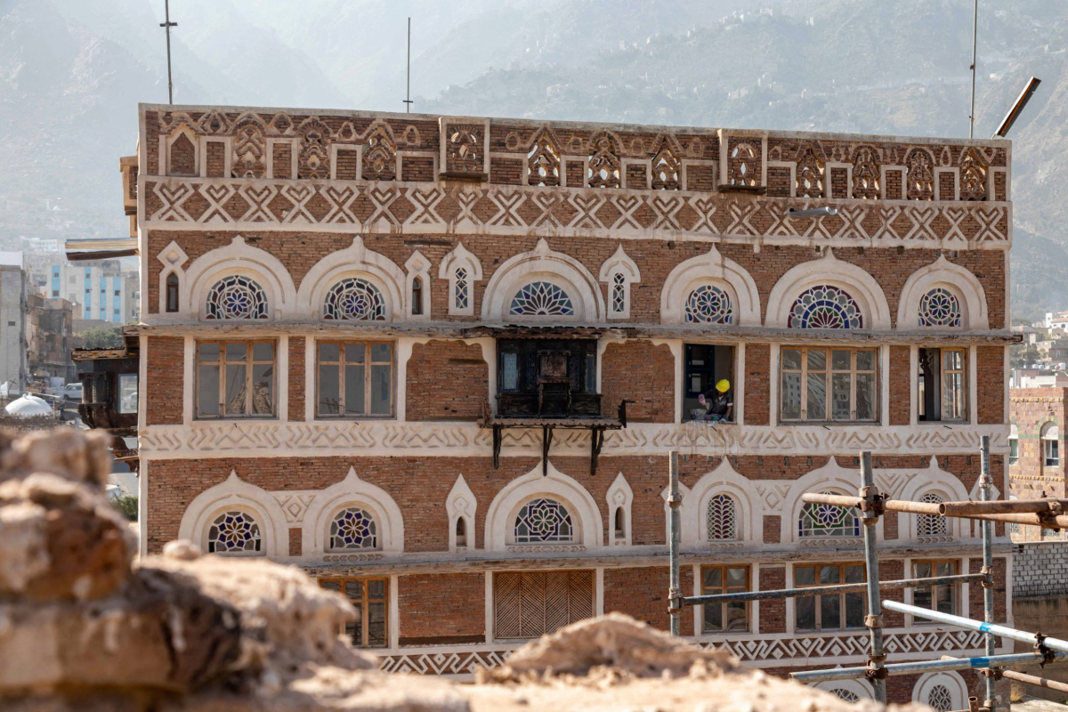 Workers repair the National Museum complex, a heritage site damaged in the war that devastated the country, in Yemen's third city of Taiz on February 22, 2022. Established as an Ottoman palace, then a residence for one of Yemen's last kings, the building became a museum in 1967 but has since then been bombed and its collections pilfered. (AFP)