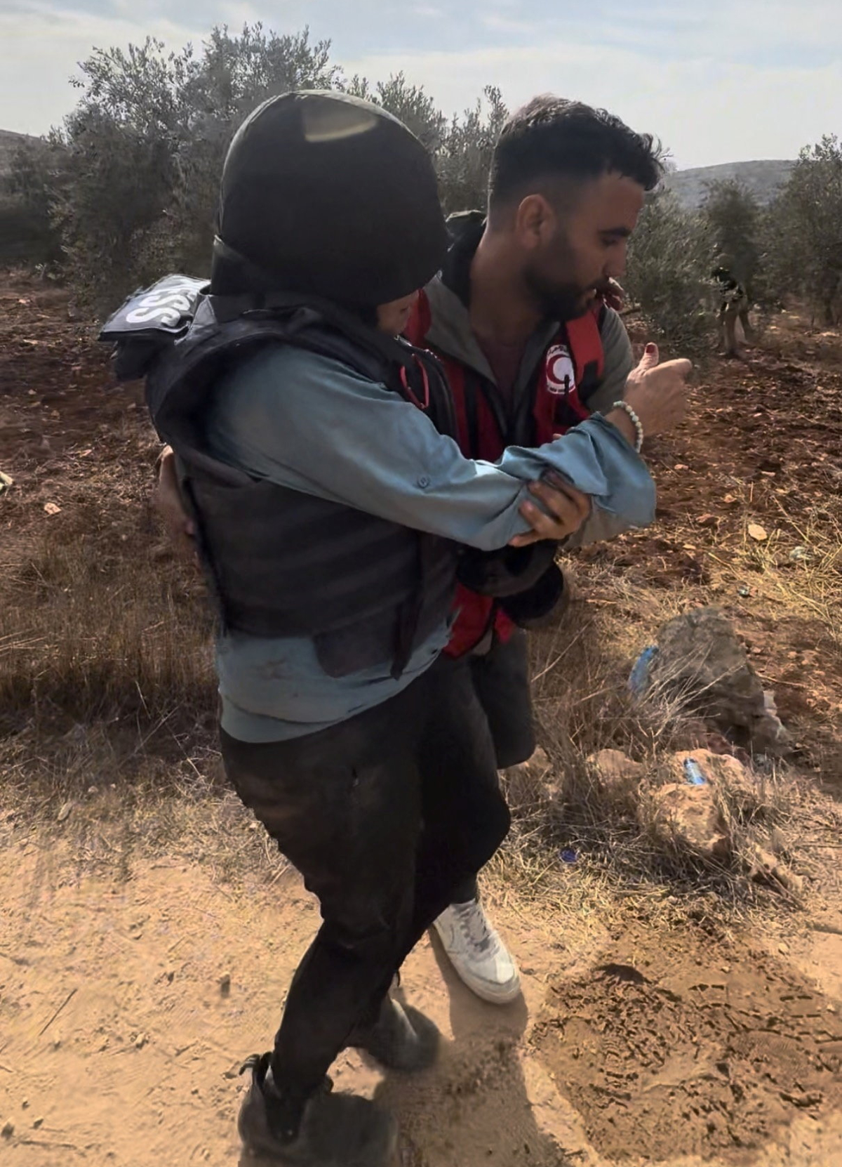 A journalist is helped after being attacked by Israeli settlers in Abu Falah, West Bank October 16, 2026, in this screengrab from a video. (Reuters)
