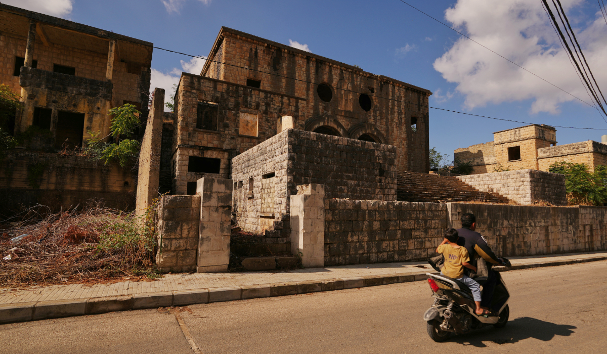 A man and a child ride a scooter past the abandoned Bhamdoun Synagogue in Bhamdoun, Lebanon, Saturday, Sept. 19, 2026. (AP)