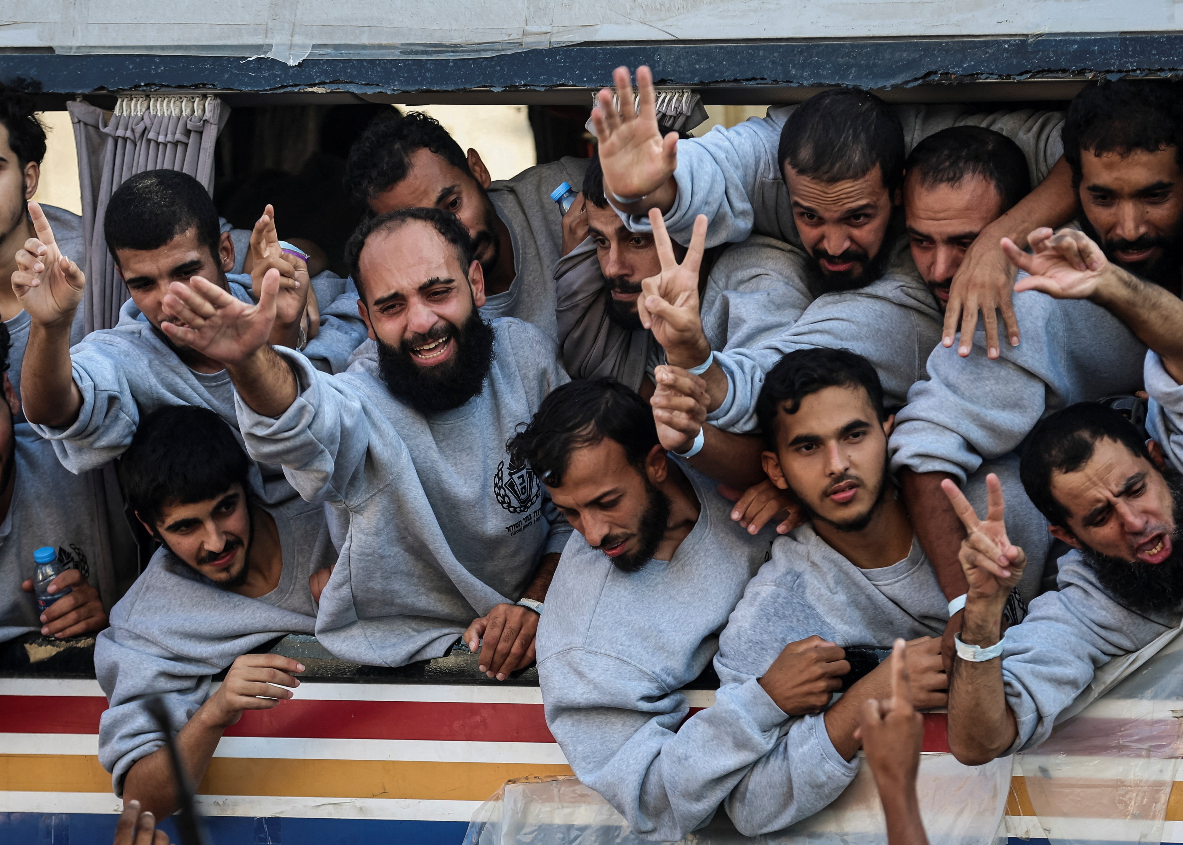 Freed Palestinian prisoners released by Israel as part of a hostages-prisoners swap and a ceasefire deal between Hamas and Israel, gesture, in Khan Younis in the southern Gaza Strip, October 13, 2025. (Reuters)
