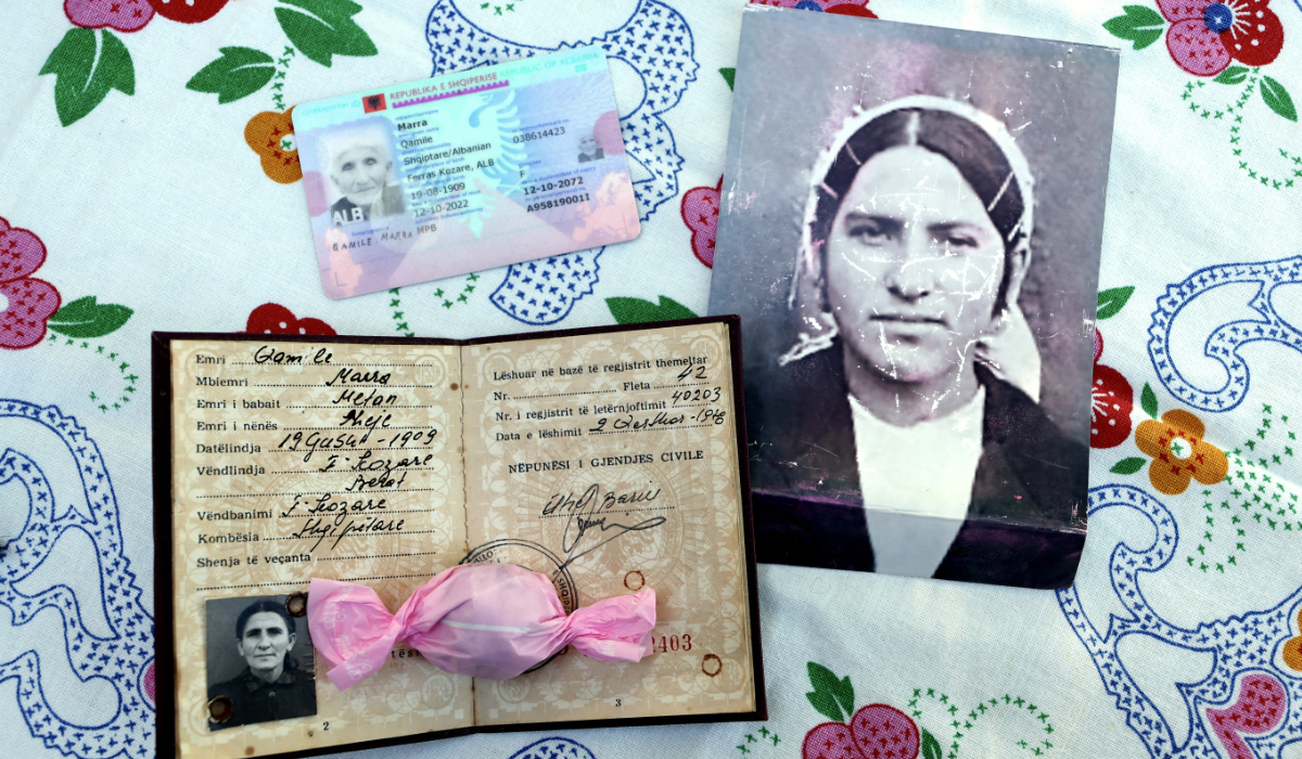 This photograph taken in the village of Ferras, near Kucove, some 80 kilometres from the capital Tirana on October 3, 2026 shows official documents indicating the date of birth of 117-year-old Qamile Marra and an old photograph of her at the age of 18 at her home. (AFP)