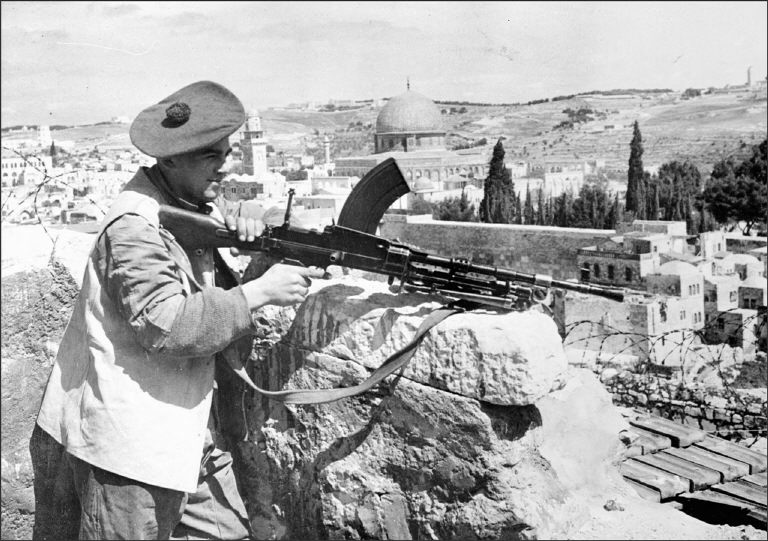 A few days before the British Mandate over Palestine ended, a British soldier, holding a British-made Bren machine gun, stands guard at the demarcation line splitting up Jerusalem between Jewish and Arab quarters, during clashes between Haganah, a Jewish force and Allied Arab forces. (AFP/File Photo)