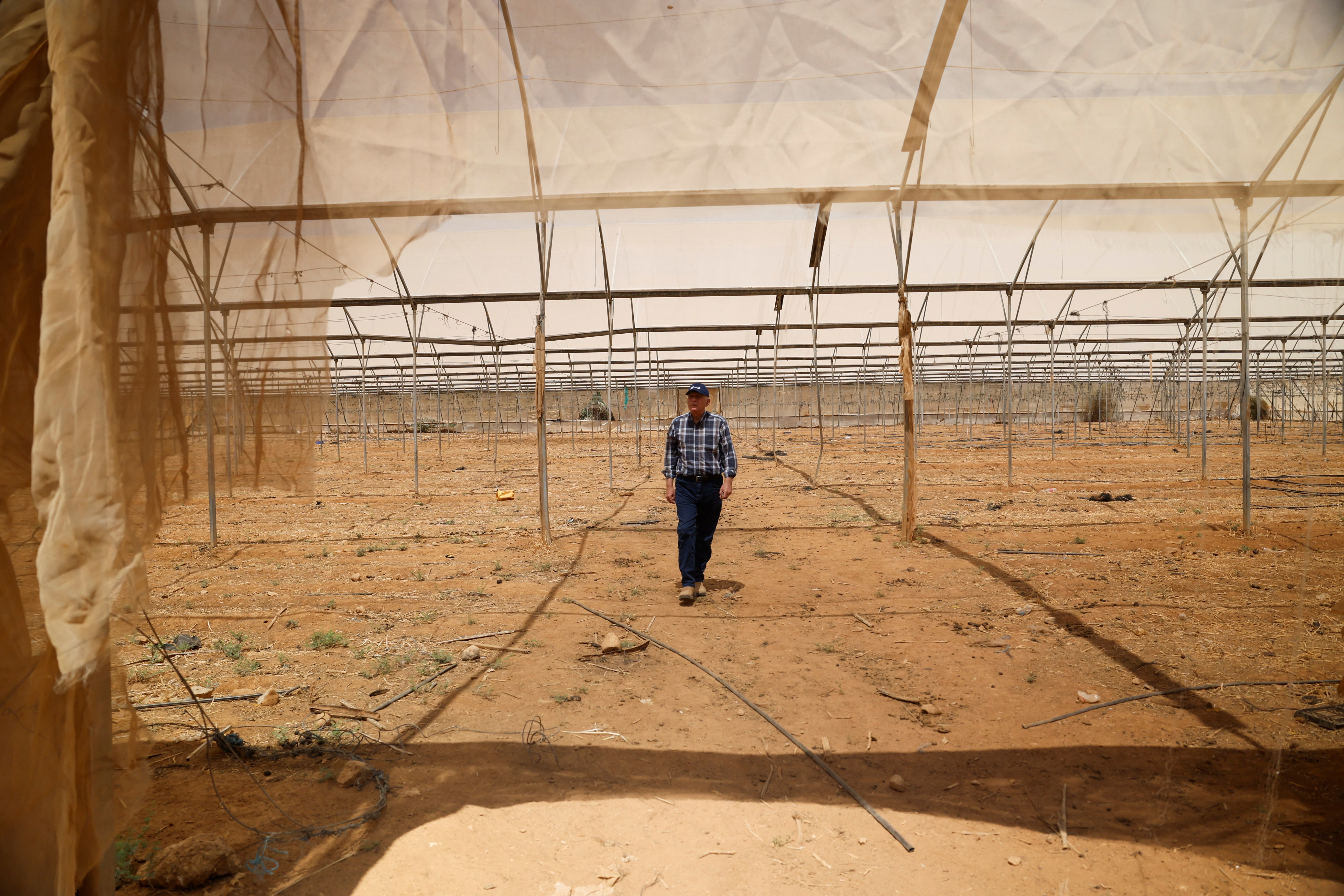 A Palestinian landowner who says that Israeli settlers diverted water from his land making it impossible to plant crops, visits his arid farm in the Palestinian village Fasayil in the Israeli-occupied West Bank, August 9, 2026. (REUTERS/Mohamad Torokman)