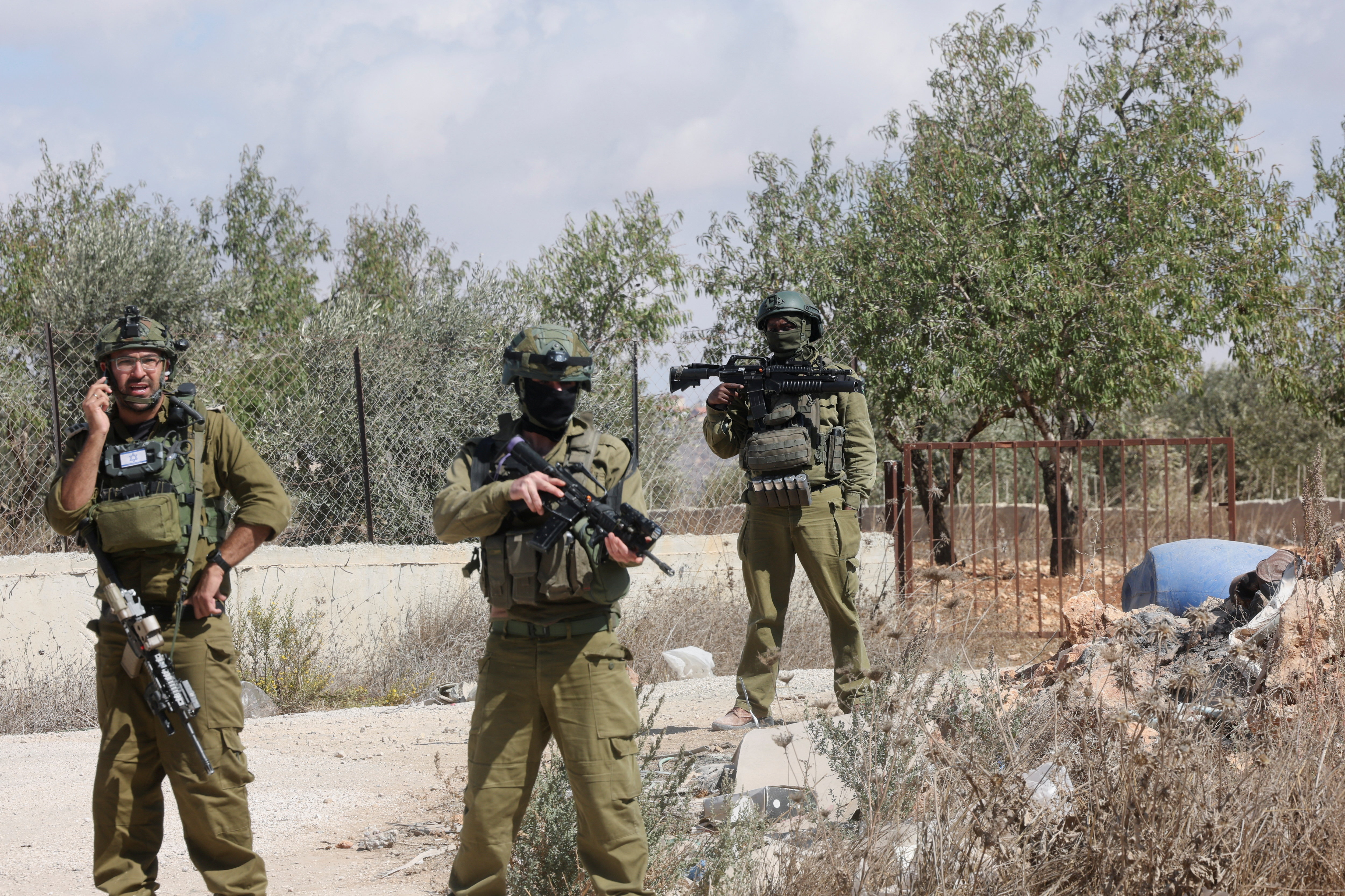 Israeli forces outside the damaged home of Palestinian Hanan Hameail following a settler attack in Turmus Ayya, occupied West Bank, Oct. 19, 2026. (Reuters/Ammar Awad)