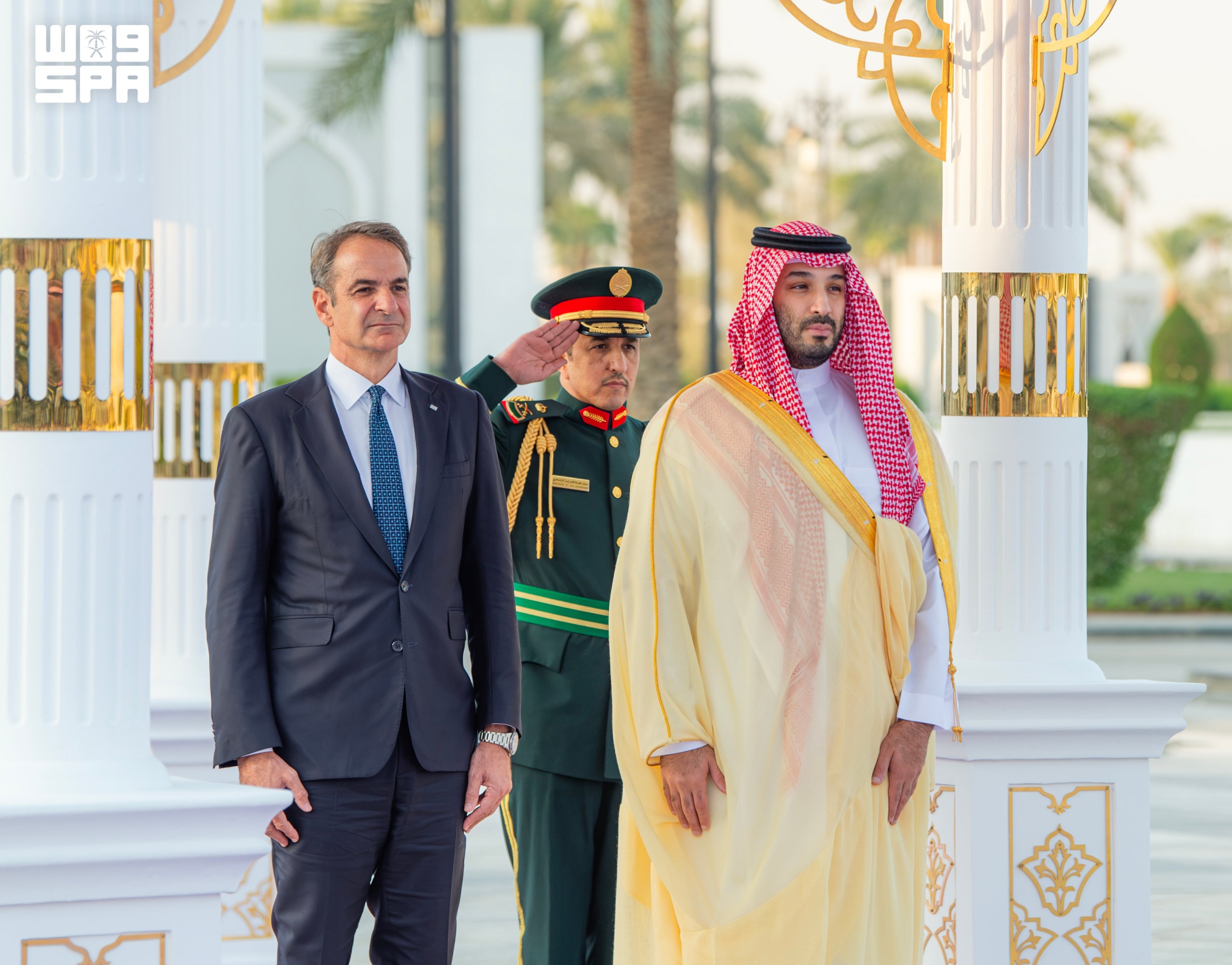 Saudi Crown Prince Mohammad bin Salman and Greek PM Kyriakos Mitsotakis observe a military salute in Riyadh on Sunday. (SPA)