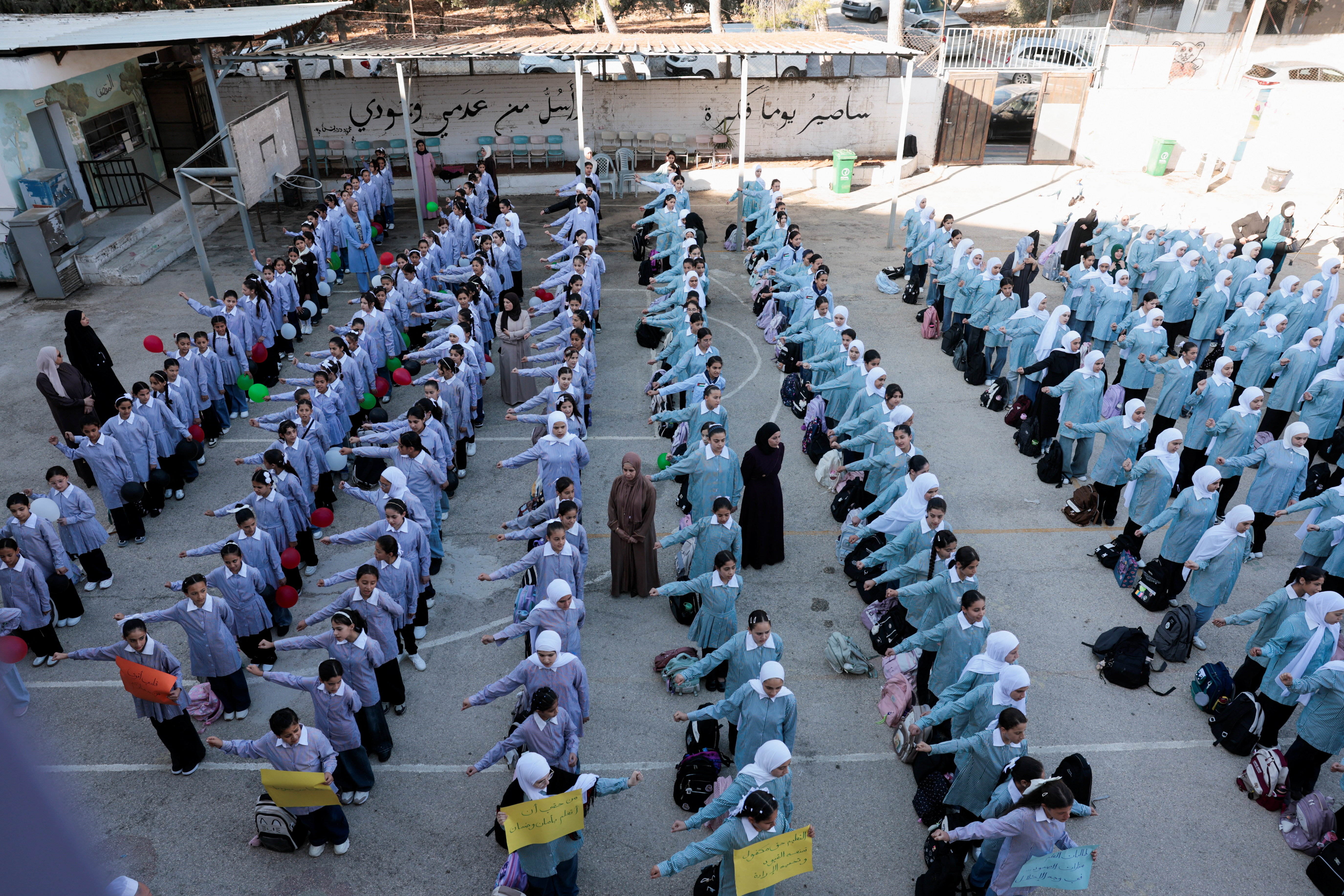 Palestinian students gather outside upon returning to school as the new academic year begins, in Qusra village in the Israeli-occupied West Bank, September 6, 2026. (Reuters)