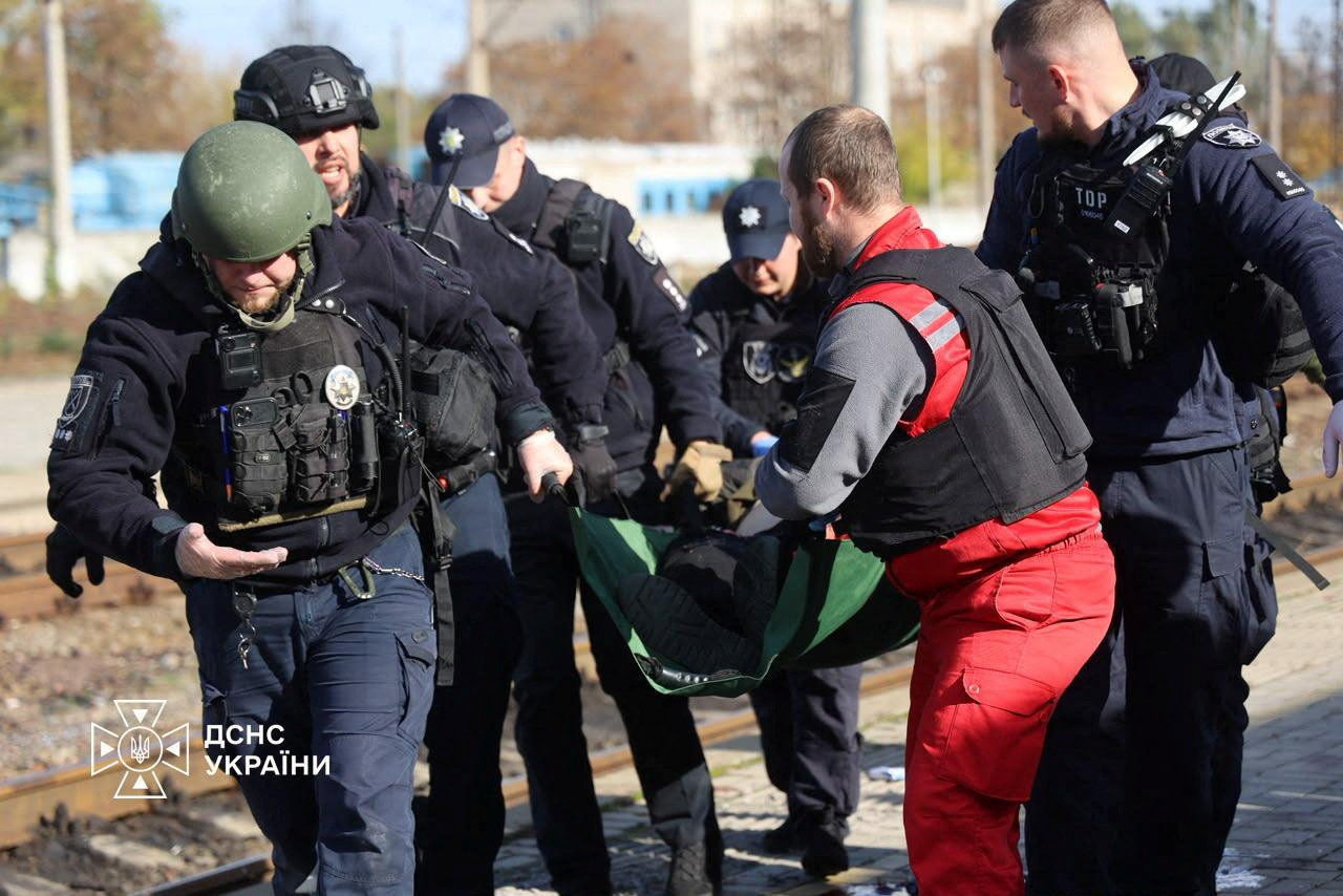 A paramedic and police officers carry a person injured at a railway station during a Russian drone strike on Dnipro, Ukraine, October 29, 2026. (Ukraine government photo / via REUTERS)