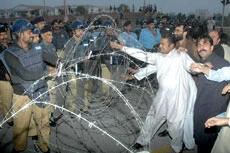 Benazir Threatens to Lead Mass Demonstration