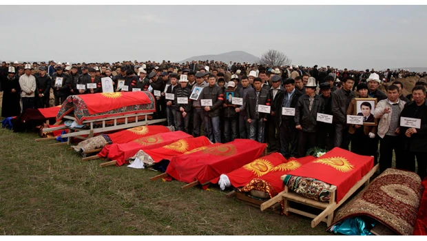 Kyrgyzstan buries its dead, US halts troop flights