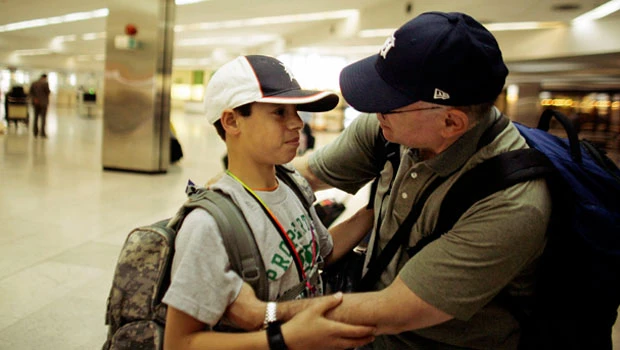 Burned Iraqi boy returns home after surgery in US