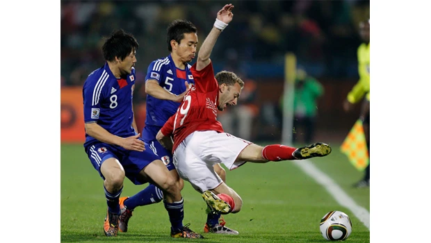 Japan beats Denmark to reach second round