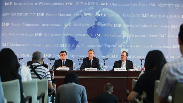IMF raises world growth forecast but risks rising