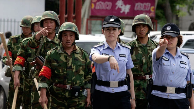 Police patrol China region on riot anniversary