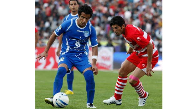Three Iranian footballers risk jail for kissing woman