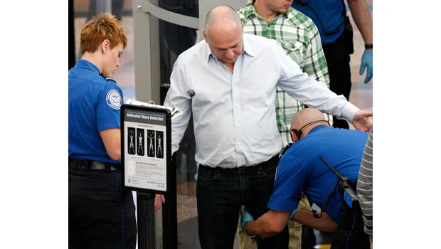 Half in survey say US airport patdowns go too far