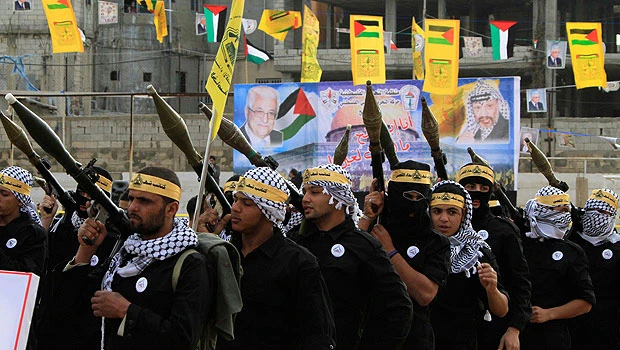 Palestinian fighters march through Lebanon camp
