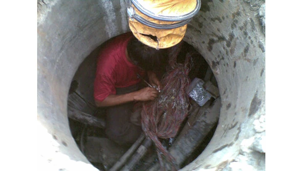 STC technicians have a hard time fixing rain-damaged phone lines