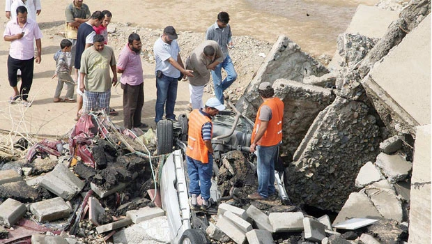 Tired waiting, residents of Jeddah district repairing roads on their own