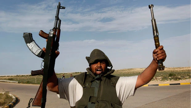 Libyan warplanes strike rebel-held oil port, Arabs weigh peace plan