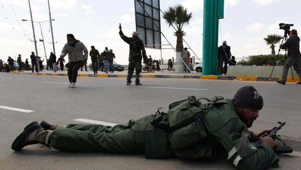 Qaddafi forces barrage rebels in east and west