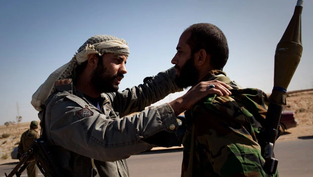 Qaddafi troops hold ground despite air assault