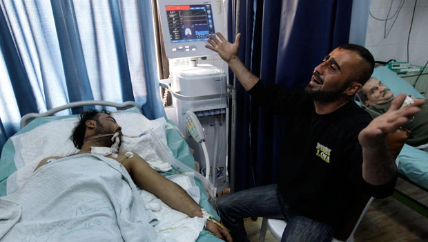 Army out in Syrian city after 12 killed