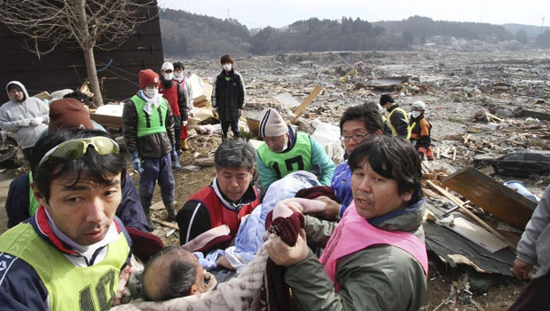 Japan begins to dig for dead amid nuclear crisis