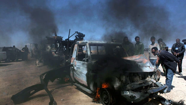 Rebels regroup in Brega as airstrike hits Qaddafi military convoy